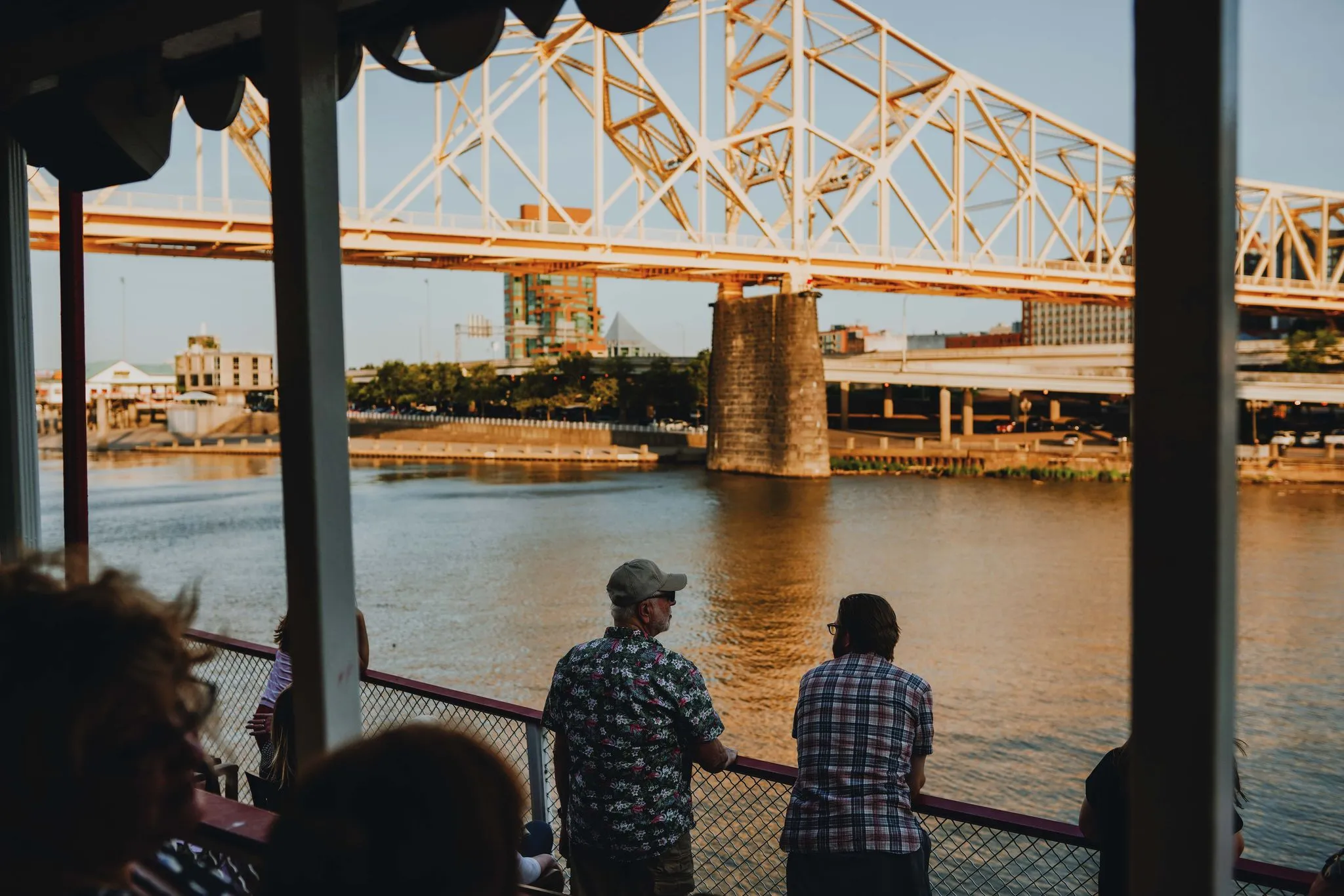 a group of people on a bridge over a body of water