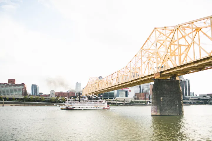 a train crossing a bridge over a body of water