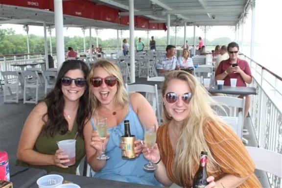 a group of people sitting at a table posing for the camera