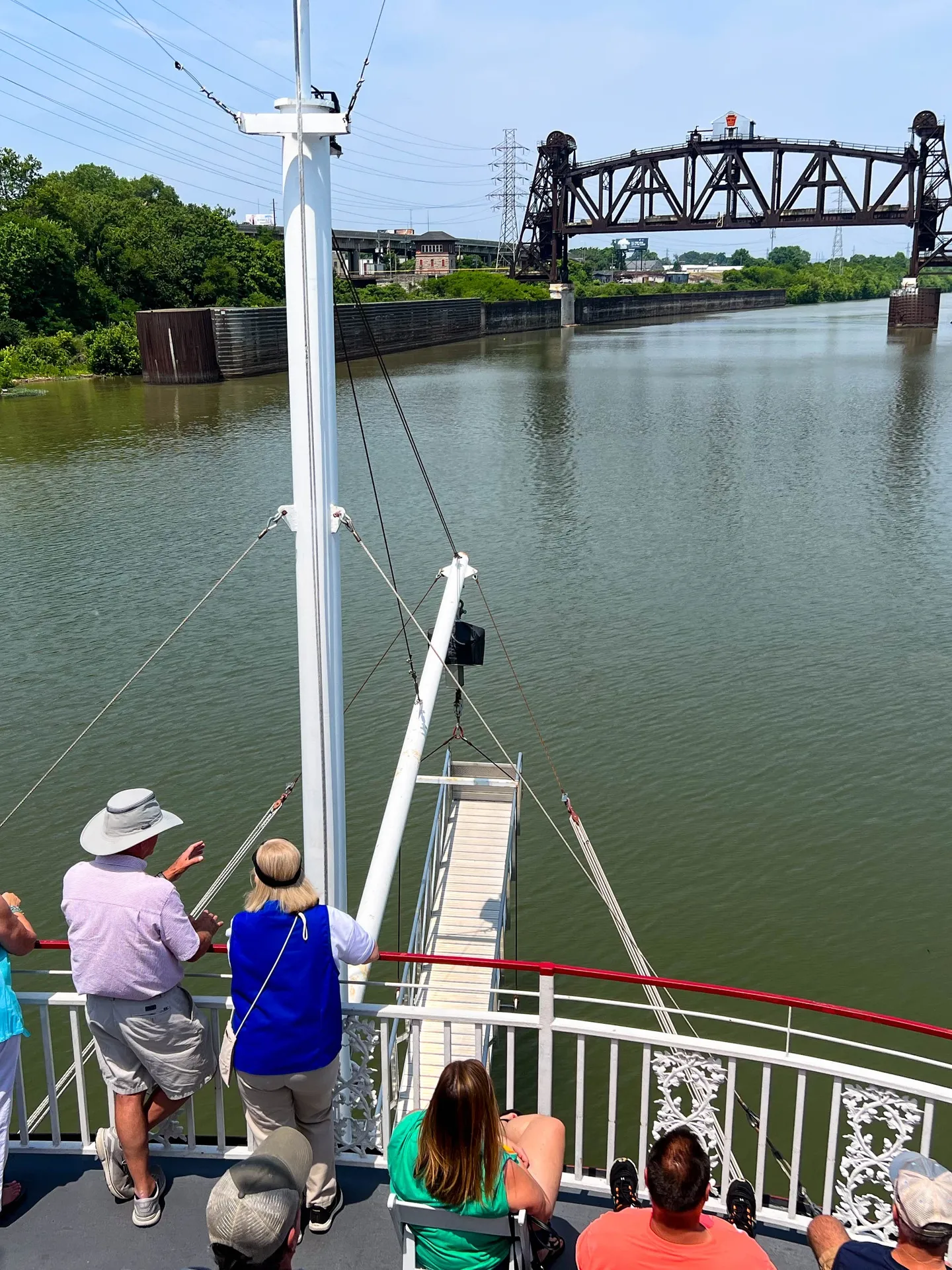 a group of people crossing a bridge over a body of water