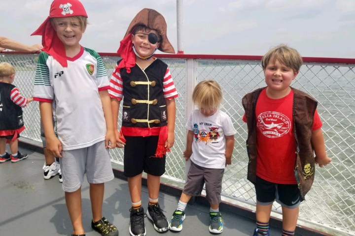 a group of people standing next to a child