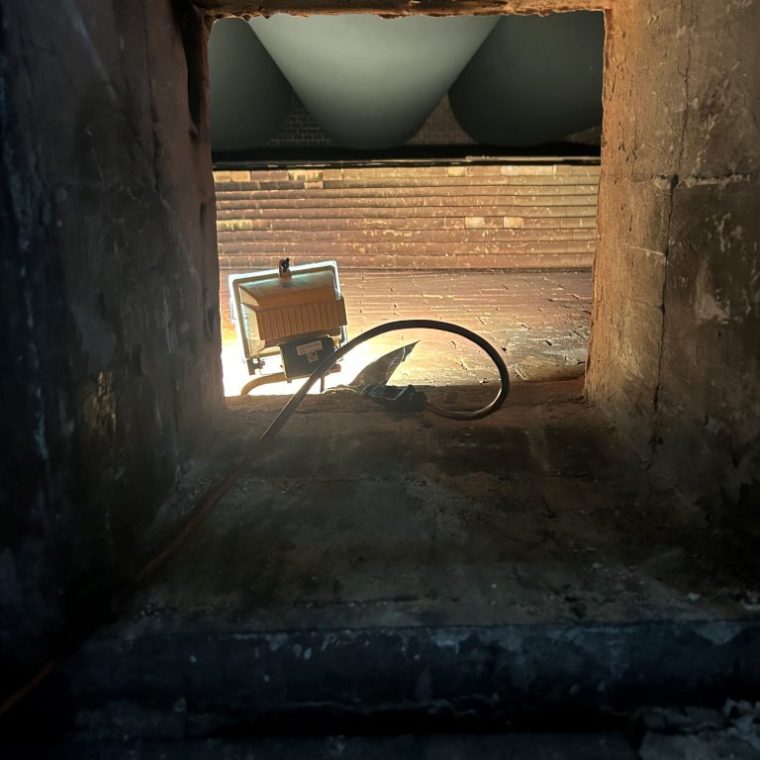 a stone building that has a bench in a dark room