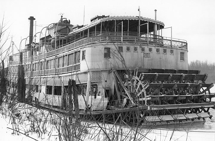 IDLEWILD-wintering-at-Alton-Slough-IL-1938 a boat sitting on top of a wooden fence