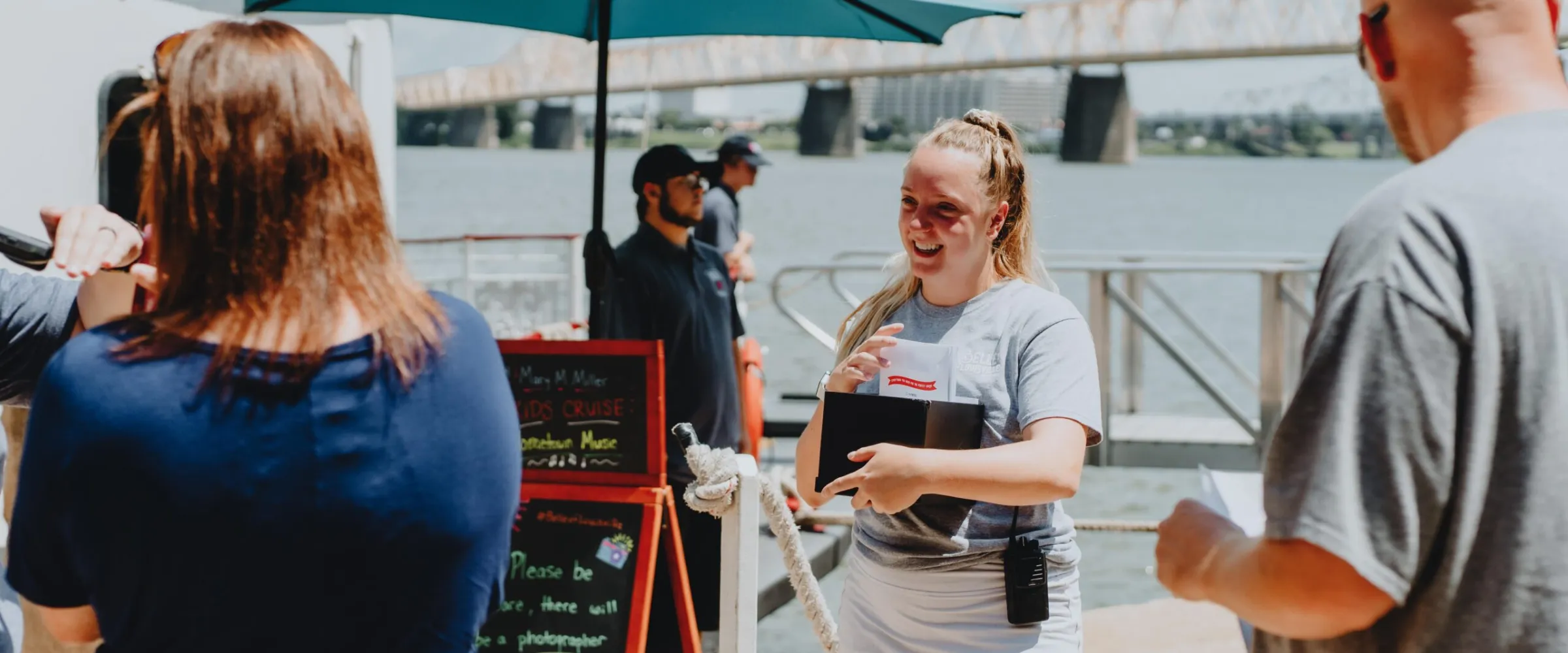 a group of people standing next to an umbrella