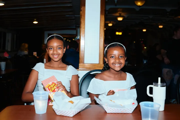 a woman sitting at a table posing for the camera
