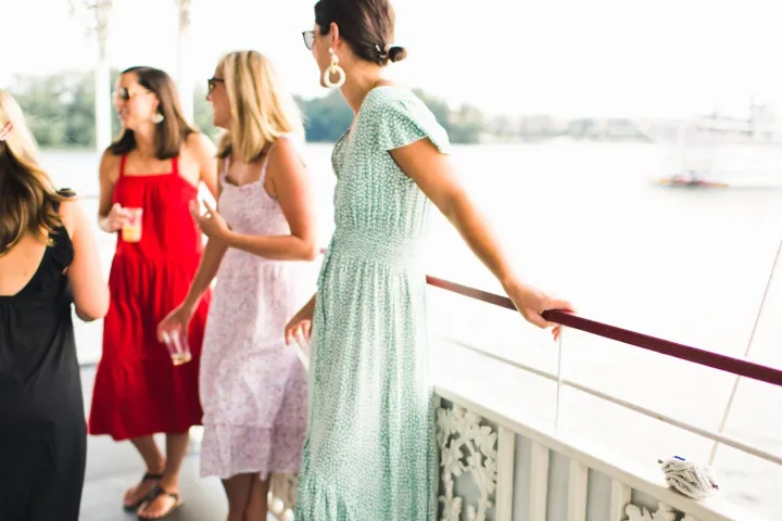 a group of people standing next to a woman